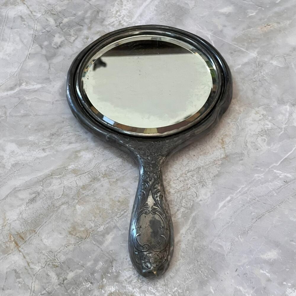 Silver Plated Hand Held Mirror with Intricate Raised Floral Scrollwork